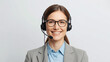 © Cortes - A smiling woman call center operator wearing a headset helps customers by phone in a business office