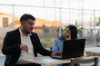© Rangel - Colleagues collaborating on laptop, experiencing disagreement and boredom during an outdoor business meeting, discussing a project with contrasting engagement