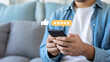 © Soyaeb - Person actively engaging with a mobile phone, providing positive feedback and a five-star rating through an online review system, highlighting digital customer satisfaction and interaction