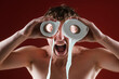 © Volodymyr - Toilet paper concept. A funny man uses toilet paper rolls as goggles. Humorous portrait with a shocked crazy expression with toilet paper. Comical lifestyle scene with toilet paper.