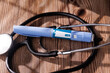 © Shutterly - Close up of semaglutide GLP-1 injection pens with a stethoscope on a dark wooden background for healthcare and medical industry use