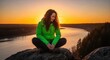 © Anna - Woman meditating on a rock during a hike at sunset. Hiker enjoying solitude while overlooking a river valley. Outdoor adventure and mindfulness in nature