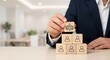 © lianlian liang - Businessman building team pyramid with wooden blocks and placing leader icon on top, concept of corporate organizational structure, human resources management, teamwork leadership and career growth.