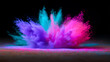 © Curioso.Photography - Vibrant explosion of blue and yellow powder captured in midair against a dark background.