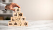 © Praphapan - Business strategy growth success planning management teamwork leadership innovation business hand stacking wooden block pyramid showing growth