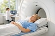 © imagemir - A calm female patient in a blue gown lies on an MRI machine, preparing for a medical scan in a bright, modern clinic.