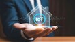© Iuliia - Man hand holding smart home with iot symbol. Internet of things technology integration for modern house management system. Digital automation concept.