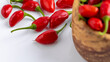 © mitsyko1971 - Vibrant red jalapeno pepper on a white background with space for text, ideal for food and culinary concepts.Group of ripe red jalapeno peppers .