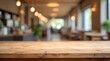 © melano - Empty rustic wooden table surface foreground with blurred cozy cafe interior background, warm lighting and bokeh effect.