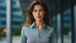 © KP - A portrait of a confident woman in a business setting, smiling confidently, she has long brown hair