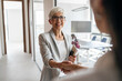 © Jelena - Business Greeting Between Professionals In A Modern Office Lobby During A Friendly Handshake