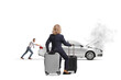 © Ljupco Smokovski - Woman sitting on a suitcase and looking at a man pushing a broken down vehicle