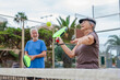 © Daniel - Portrait of couple of mature people playing padel game outdoors in a paddle tennis court together. Old man and mature woman teammate having fun enjoying
