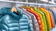 © syhin_stas - shelves with large selection of modern down jackets in sports store, retail shopping interior, winter outerwear display, active lifestyle and outdoor fashion concept