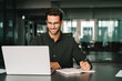© Stock 4 You - Young student man using laptop computer for business studying, watching online webinar training meeting, video call. Businessman entrepreneur businessman working writing notes in office. Copy space