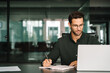 © Stock 4 You - Middle-age European man using laptop computer for business studying, watching virtual webinar training writing notes. Focused young Latin businessman student working in office online, copy space