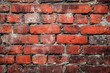 © mehaniq41 - Close-up view of red brick wall featuring weathered textures and darkened grout. Predominant use of red and black tones under natural lighting. Neural network AI generated
