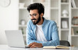 © Prostock-studio - Networking Concept. Handsome Young Indian Guy Browsing Internet On Laptop Computer, Smiling Happy Eastern Man In Eyeglasses Sitting At Desk In Home Office, Working Or Study Online, Copy Space