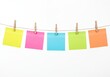 © Asad - Multicolored sticky notes hanging on string isolated on white background, creative planning and workflow concept for business organization, teamwork, and visual communication.
