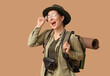 © Pixel-Shot - Happy young female tourist with backpack on beige background
