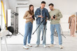 © Pixel-Shot - Photographers with cameras and tripod during master class in studio