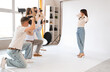 © Pixel-Shot - Photographers taking pictures of model during master class in studio