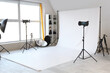 © Pixel-Shot - Interior of photo studio with white backdrop and professional equipment