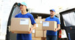 © Pixel-Shot - Delivery men carrying boxes to client