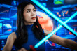 © BuabarnCH - Futuristic cyber warrior woman holding glowing energy lights sword before advanced digital screens, science fiction combat, virtual reality, power, defense, innovation, and high tech imagination.