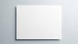 © Si_Design - Blank white square paper mockup with a gentle shadow on a clean gray background, providing ample copy space for minimalist design presentations.