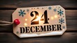 © Mizan - Close up of a rustic wooden Christmas eve sign displaying the date December 24 with festive lights