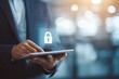 © elbanco - Businessman using tablet with digital padlock icon for cybersecurity.