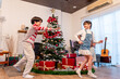 © Kawee - Lovely Asian family celebrating Christmas party together at cozy home.