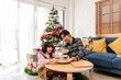 © Kawee - Asian father and daughter prepare desserts during Christmas celebration.