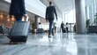 © Nadiia - Business people with luggage walking through bright hotel lobby with marble floor and modern interior