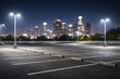 © Handy - Empty city parking lot at night with illuminated skyline background
