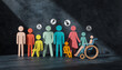 © Athiphat - Inclusive community concept with diverse wooden people figures, various colors, sizes, and abilities, including wheelchair and child, under spotlight, symbolizing unity and acceptance
