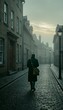 © Mr. Stocker - Man walks down a cobblestone street lined with old stone buildings, disappearing into the atmospheric mist of a quiet, historic town.