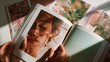 © stasja - Woman holding fashion magazine while looking at editorial photos