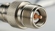 © musa - Close-up of a silver coaxial cable connector for radio frequency applications.