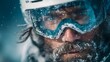 © horizon - Close-up portrait shows a male skier wearing a white helmet and reflective blue goggles with snow dusting his beard in a winter mountain scene.
