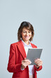 © Stock 4 You - Isolated vertical portrait of successful smiling latin mature woman in suit using pad computer for business. Executive CEO businesswoman office professional holding digital tablet pc device for work