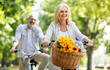 © Prostock-studio - Active Retirement. Beautiful Senior Woman Riding Bycicles With Her Husband In Park, Happy Mature Man And Woman Enjoying Outdoor Leisure, Making Bike Ride And Having Fun Together Outside, Free Space