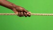 © Kila - Powerful hand firmly gripping thick natural rope against vibrant green background, symbolizing strength, effort, challenge, and determination.