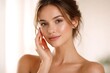© Bellal Mollik - Beauty portrait of young brunette woman touching fresh clean face with healthy skin looking at camera on white background