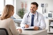 © Bellal Mollik - Smiling male doctor consulting female patient at desk in medical clinic office during appointment
