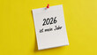 © Insane Stocks - Motivation message 2026 ist mein Jahr written on notebook paper pinned to a bright yellow background