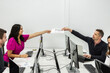 © Juan Algar - Business professionals exchanging documents in a coworking space