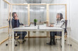 © Juan Algar - Meeting in shared workspace with partitions for privacy and focus on collaboration