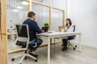 © Juan Algar - Coworking space with two people engaged in work at a shared desk